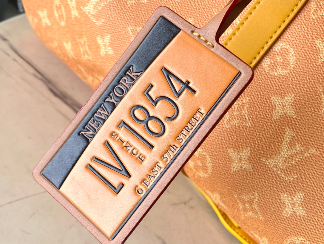 KEEPALL BANDOULIÈRE 55 EN TOILE HERITAGE MONOGRAMME ORANGE