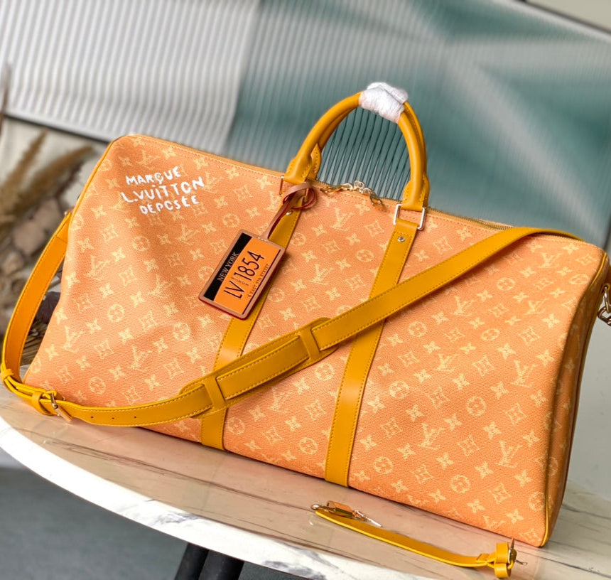KEEPALL BANDOULIÈRE 55 EN TOILE HERITAGE MONOGRAMME ORANGE