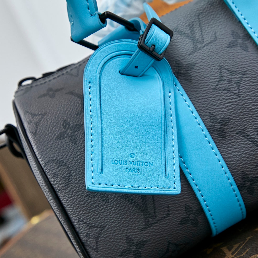KEEPALL BANDOULIÈRE 25 EN MÉTAL GAZON MONOGRAMME ECLIPSE TOILE MIXTE CUIR DE VEAU TURQUOISE